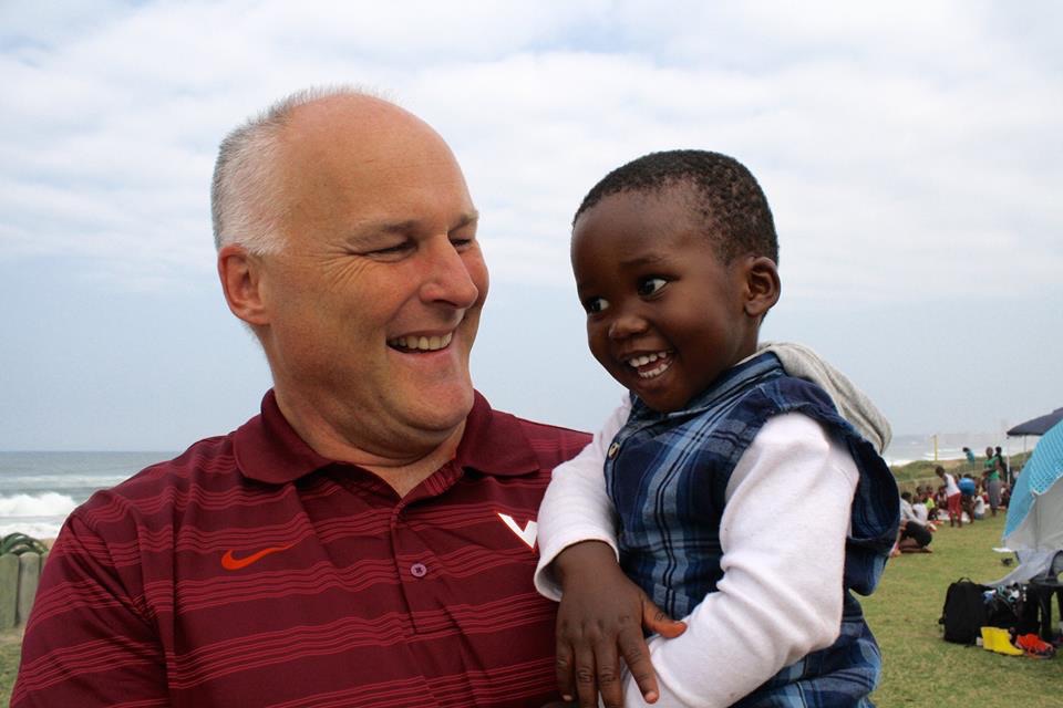 A friend of the mission holding a young child from Ntshongweni
